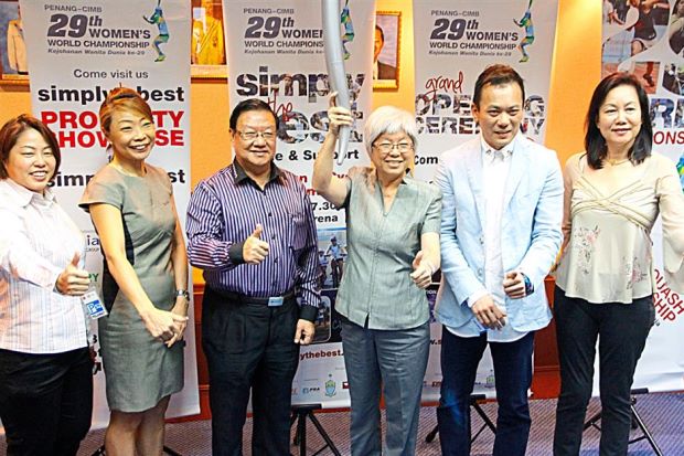 See you there: Chong (third right) holding the torch which will be used in the Torch Run and Bike event. With her are sponsors of the championship.